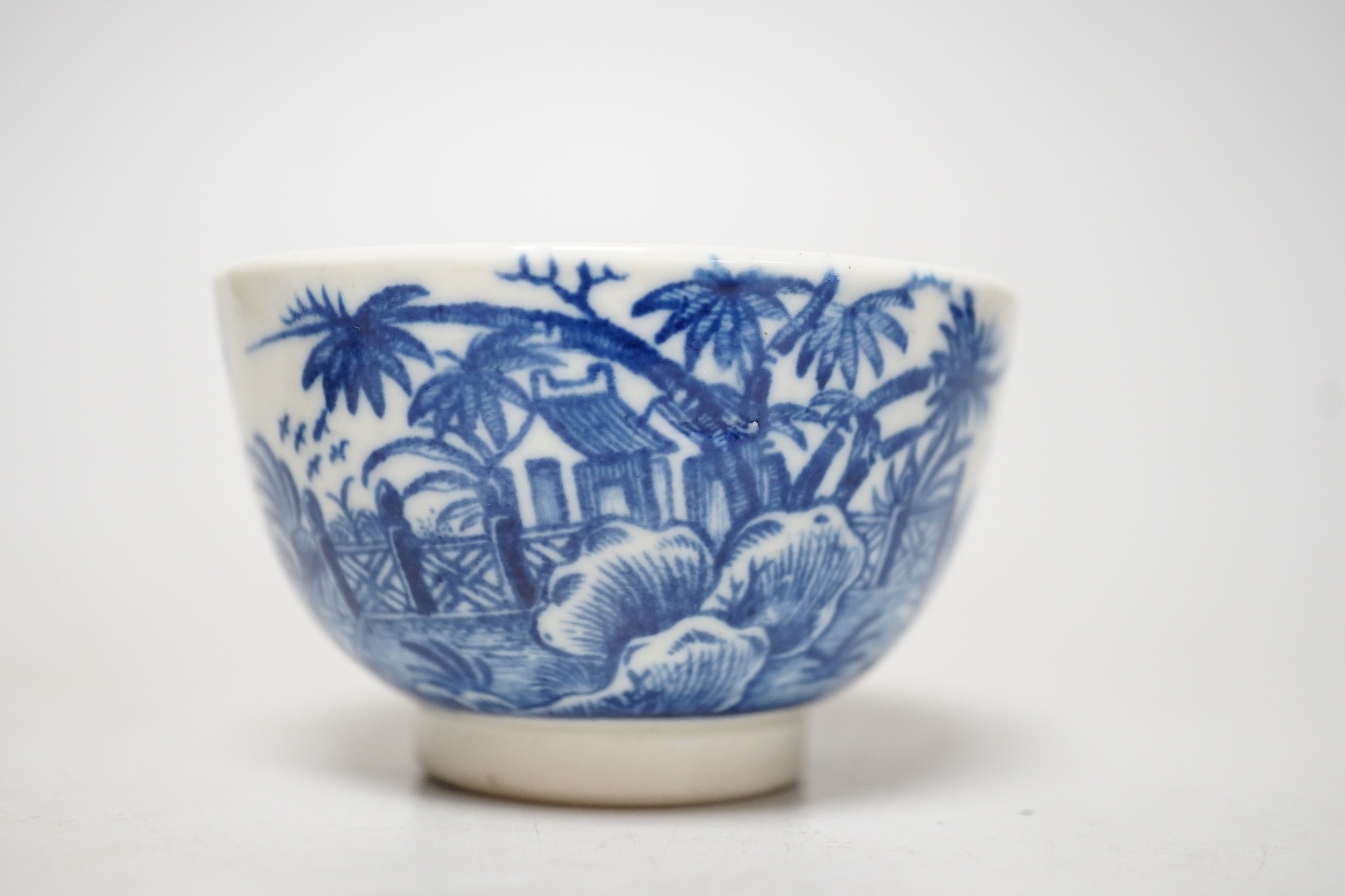 An 18th century Caughley teabowl and saucer printed with the uncommon Fence and House pattern. 6cm tall overall